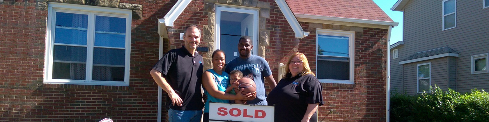 Photo of new home owners with ESOP staff